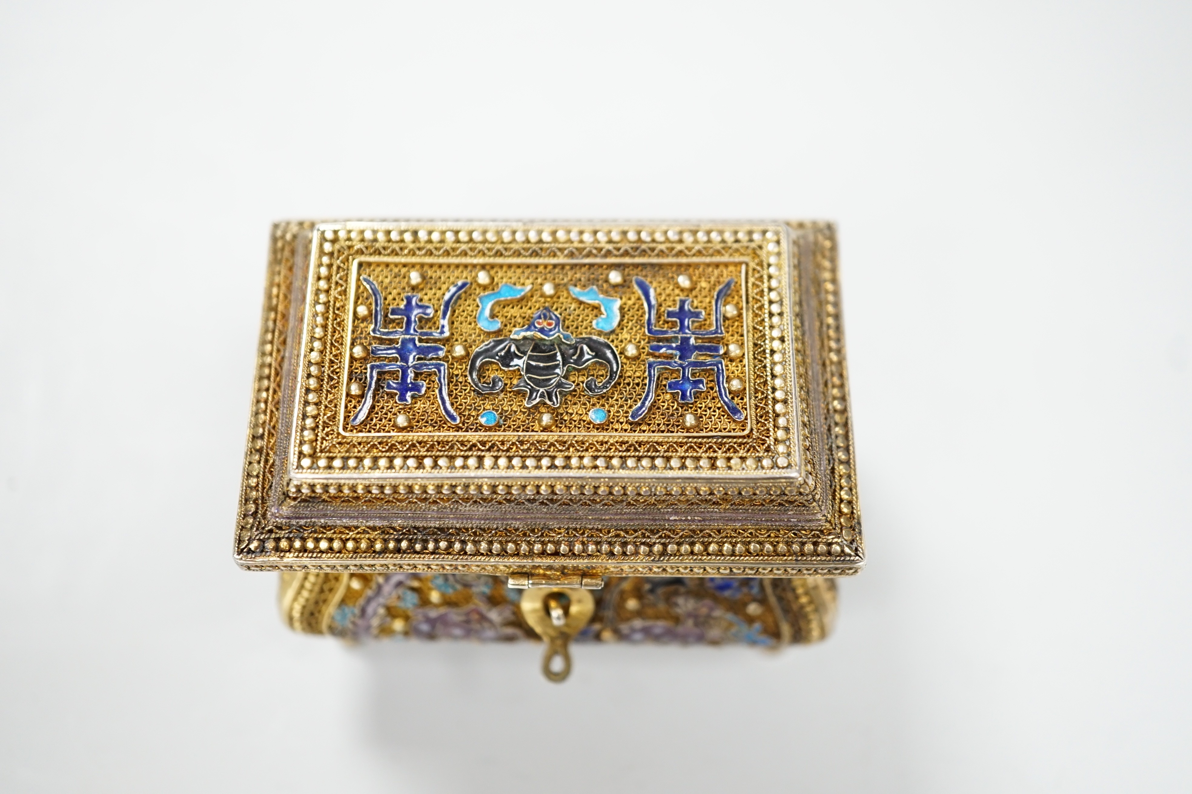 A Chinese gilded filigree white metal and enamelled trinket box, stamped 'silver', width 63mm, gross weight 76 grams.